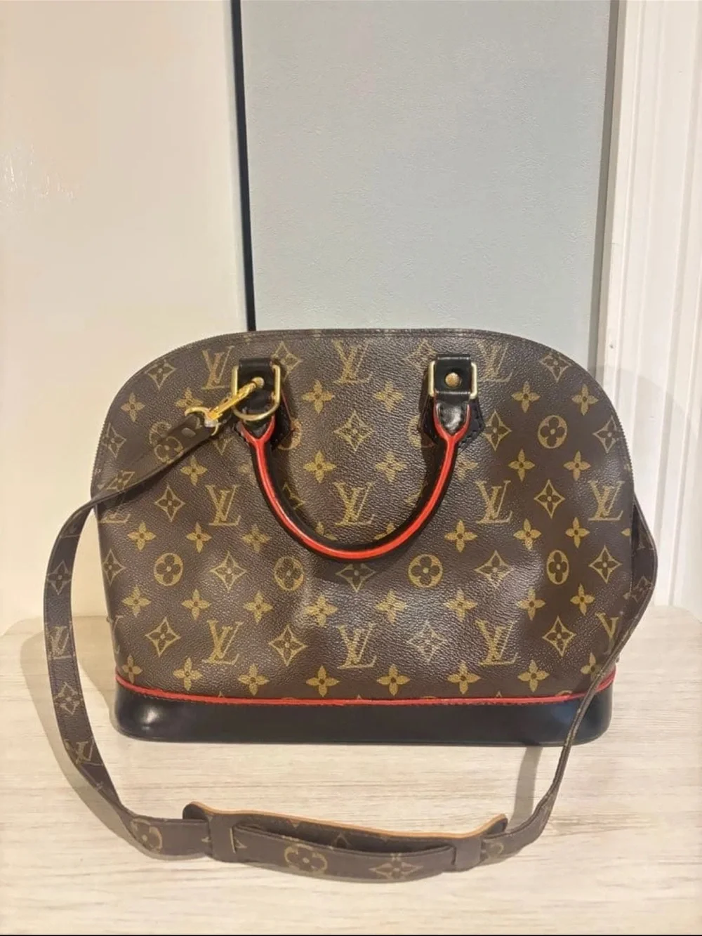 Louis Vuitton Monogram Alma Satchel in Brown with Red Trim